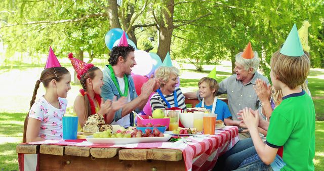 Multi-generational family celebrating birthday outdoors - Download Free Stock Images Pikwizard.com