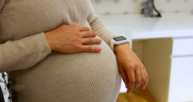 Pregnant Woman with Smartwatch Holding Her Belly - Download Free Stock Images Pikwizard.com