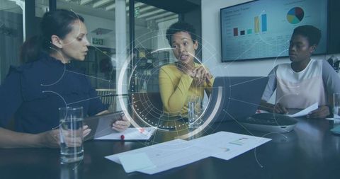 Businesswomen Leading Collaborative Meeting With Data Visualization and Team Presentation