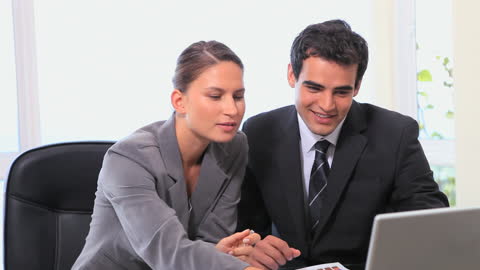 Young Business Colleagues Collaborating at Office Desk