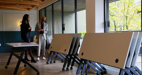 Collaborating bairacial colleagues in contemporary office space