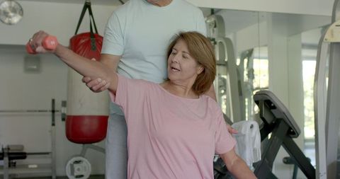 Senior Couple Enjoying Fitness Routine in Gym Environment