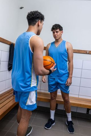 Teenage Basketball Players in Locker Room Preparing for Game