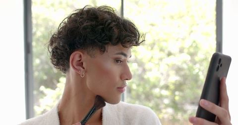 Man Applying Makeup with Smartphone Reflection Natural Light