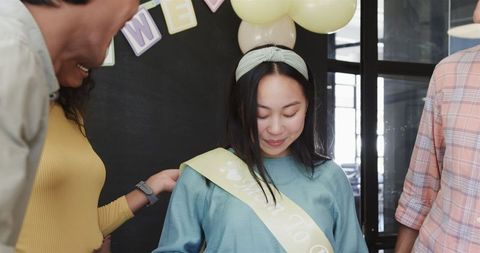 Colleagues celebrating baby shower in workplace gathering