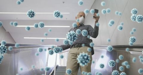 Man wearing face mask surrounded by digital virus particles