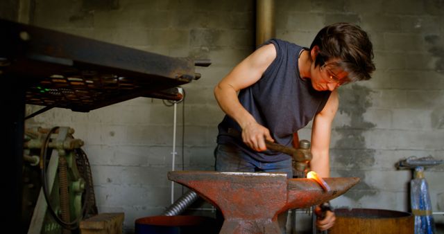 Female Blacksmith Forging Metal in Rustic Workshop - Download Free Stock Images Pikwizard.com