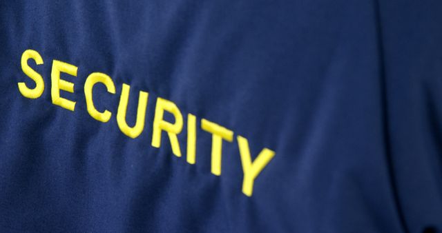 Close-Up of Security Officer Uniform with Yellow Text - Download Free Stock Images Pikwizard.com