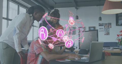 Coworkers collaborating on laptop visualizing holographic network globe in open office team