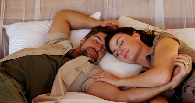 A young Caucasian couple is peacefully sleeping together, with copy space. Their relaxed expressions and close proximity suggest a deep comfort and intimacy with each other.