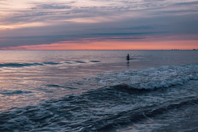 Person Standing in the Sea during Sunset - Download Free Stock Photos Pikwizard.com