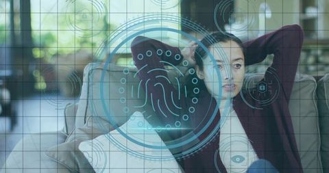 Relaxed woman using biometric security interface at home