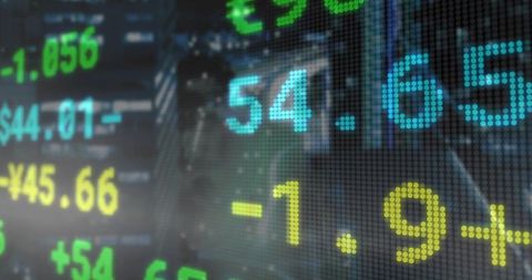 Fluctuating stock and currency ticker on trading floor display