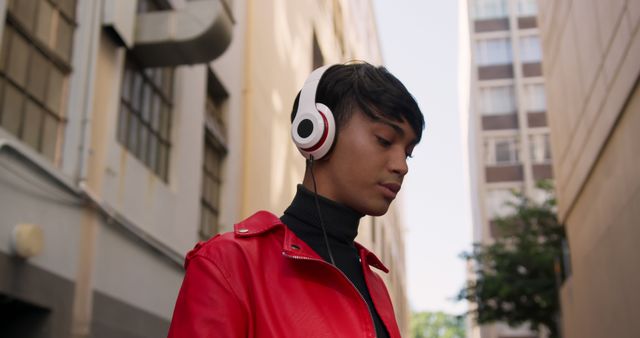 Young Man with Headphones Wearing Red Jacket in Urban Alleyway - Download Free Stock Images Pikwizard.com