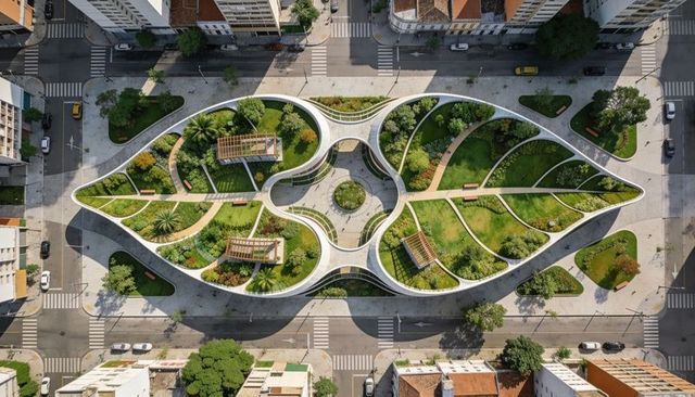 Leaf-shaped urban park with curving planters, pergolas and walkways — aerial green plaza