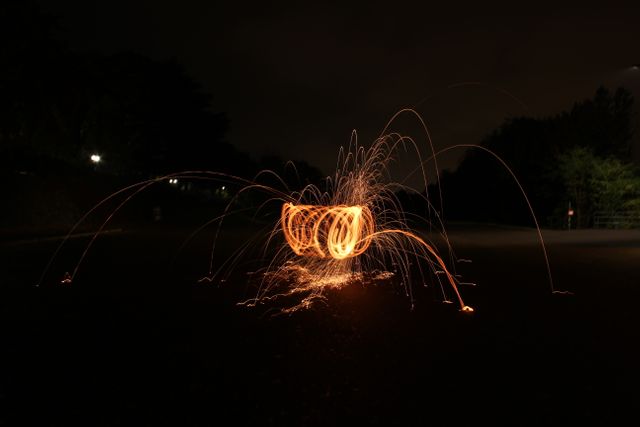 Vivid and striking long exposure capturing dynamic light trails in an outdoor night setting. Ideal for use in creative projects, photography tutorials, background images, and artistic inspiration. Perfect for illustrating concepts like creativity, energy, and movement.