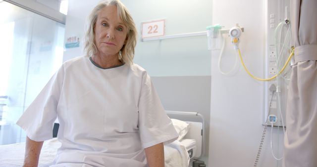 Senior Woman Sitting on Hospital Bed in Gown - Download Free Stock Images Pikwizard.com