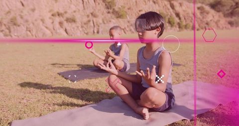 Children practicing yoga meditation outdoors