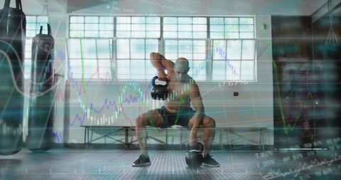 Shirtless athlete lifting kettlebells overhead in industrial gym with finance chart overlay
