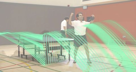 Celebrating indian table tennis victory in gymnasium with paddle raised and dynamic light trails