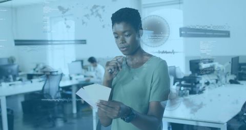 African American Businesswoman Analyzing Informative Data in Modern Office