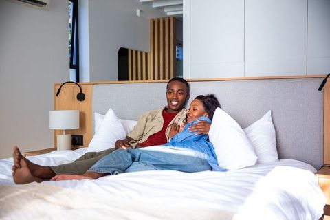 Romantic African American Couple Relaxing in Cozy Modern Bedroom