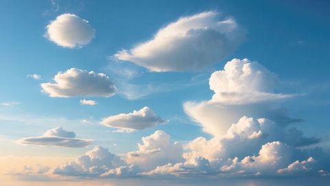 Majestic Clouds Illuminated By Sunlight in Tranquil Blue Sky