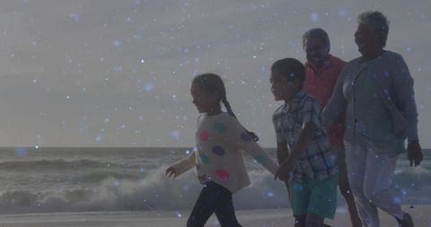 Multigenerational Family Strolling by Ocean as Waves Gently Crash