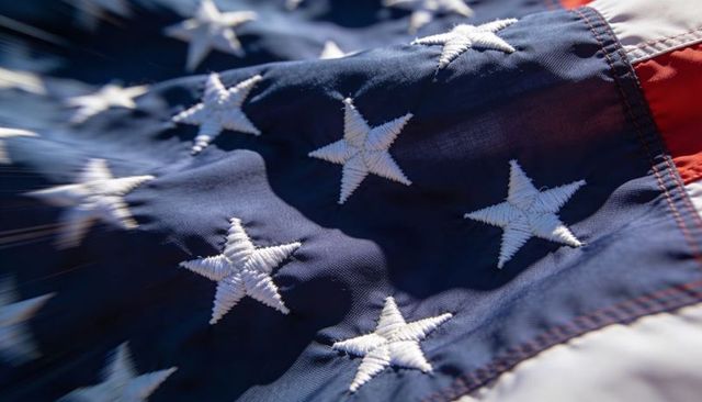 Close-up american flag canton with stitched stars waving in sunlight