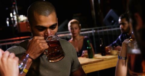 Friends Enjoying Beers at a Cozy Pub Gathering