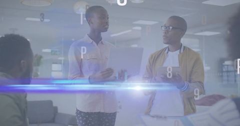 Team presenting with laptop and tablet in futuristic open office collaboration