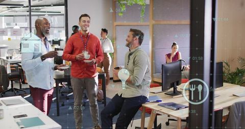 Diverse team sharing laughs during office coffee break