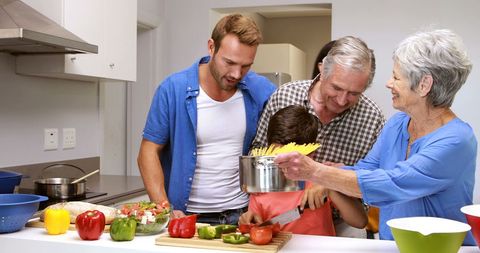 Multi-Generational Family Cooking Together Joyfully in Modern Kitchen