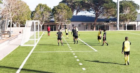 Competitive soccer match on school field imposes energy and team spirit