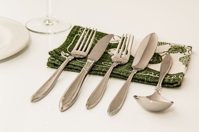 Elegant Cutlery on Green Napkin with White Background - Download Free Stock Photos Pikwizard.com