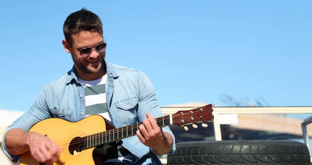 Man Playing Acoustic Guitar Outdoors on Sunny Day - Download Free Stock Images Pikwizard.com