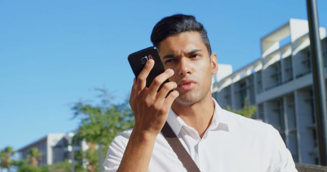 Businessman using smartphone outdoors in city - Download Free Stock Images Pikwizard.com