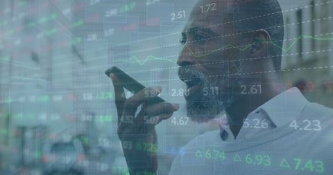 African American Man Multitasks with Smartphone and Data Interface