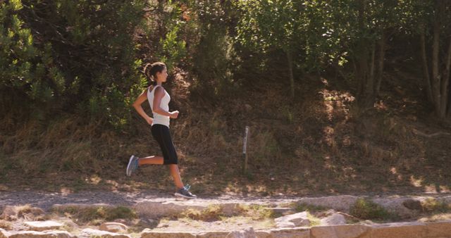 Woman Jogging Outdoors on Narrow Trail in Forest Setting - Download Free Stock Images Pikwizard.com