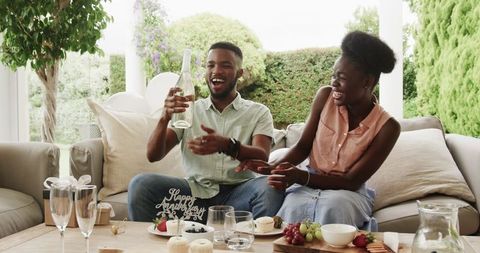 Couple Celebrating Special Occasion with Champagne Outdoors