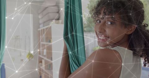Smiling Teenage Girl Enjoying Aerial Yoga Outdoors with Glowing Network Overlay