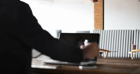 Caucasian businessman working with laptop in creative office space