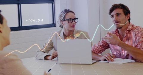 Business team discussing data visualization, strategy with laptop and digital graph overlay