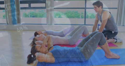 Group Exercise Class with Instructor Leading Sit-up Routine