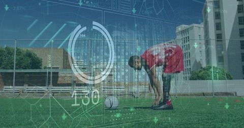 Prosthetic athlete analyzing data on soccer field