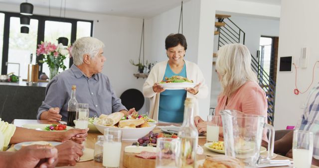 Cheerful Family Gathering for Meal Around Dining Table - Download Free Stock Images Pikwizard.com