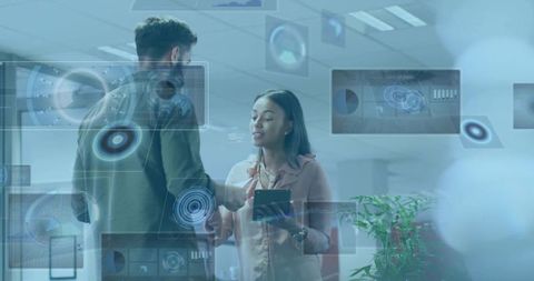 Colleagues Collaborating with Holographic Data Displays Using Tablet in Modern Office Workspace