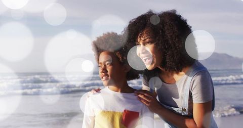 Mother and Son Enjoying Scenic Beach with Ethereal Lens Flare Effect