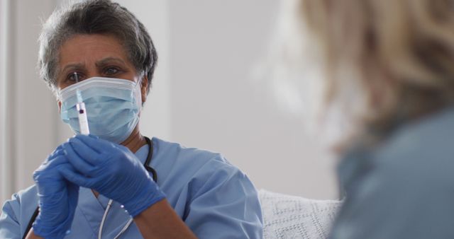 Healthcare professional preparing syringe for senior patient - Download Free Stock Images Pikwizard.com