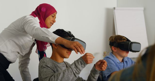 Teacher Guiding Students Using Virtual Reality Headsets in Classroom - Download Free Stock Images Pikwizard.com